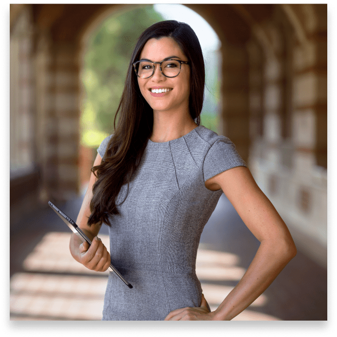 a young woman standing in a walkway at a college